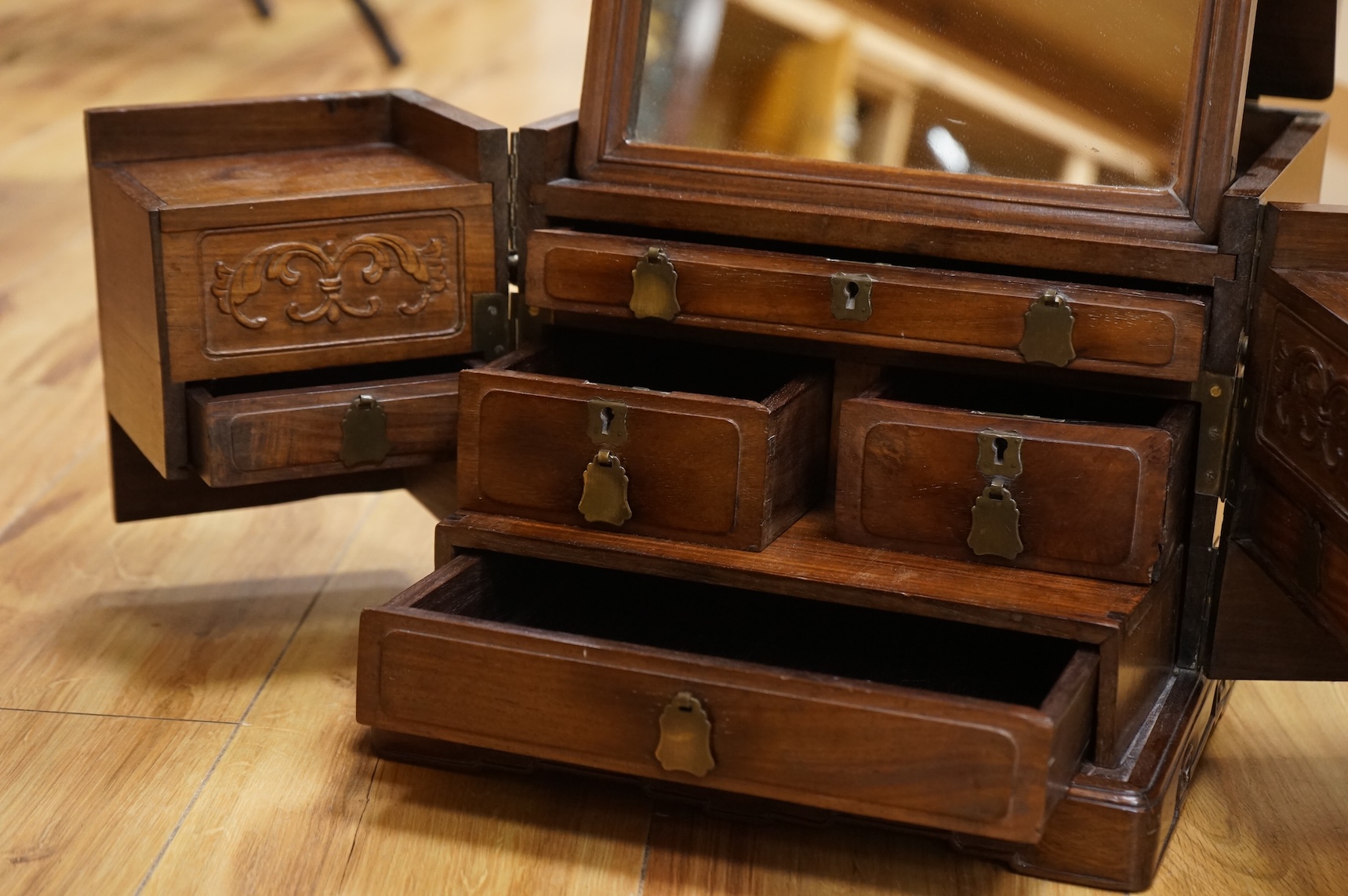 A Chinese rosewood brass bound dressing chest, closed 39cm deep, 29cm wide, 23cm high.